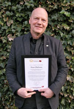 Finn Olafsson showing his ambassador diploma